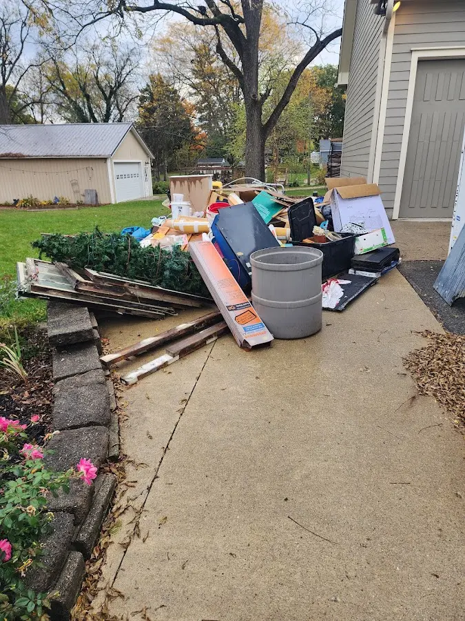 Dumpster being loaded with debris for Roofing Dumpster Rental in Leisure City